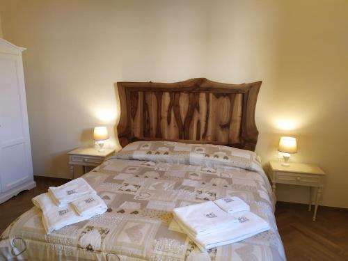 a bedroom with a bed with towels on it at Il Mulino di Celle in Pistoia