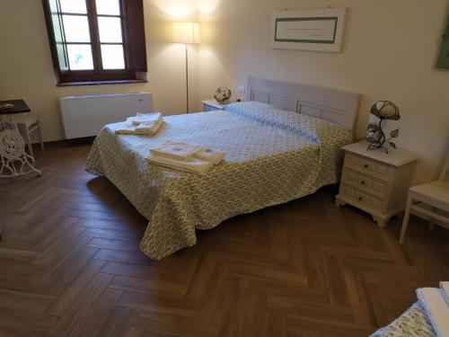 a bedroom with a bed with two towels on it at Il Mulino di Celle in Pistoia