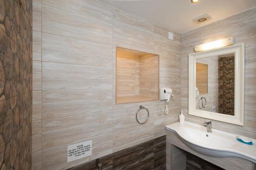 a bathroom with a sink and a mirror at Villa Bacchus Kassiopi Corfu in Kassiopi
