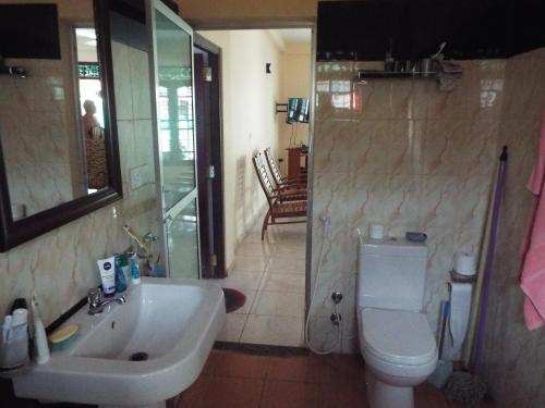 a bathroom with a sink and a toilet and a shower at Ceylon Epic Inn in Bentota