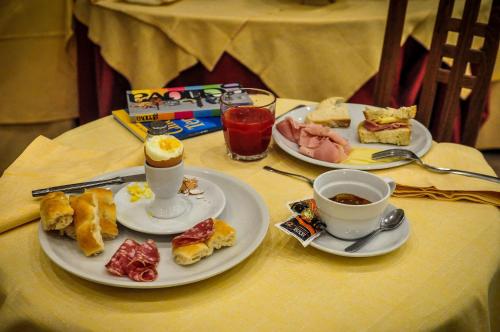 a table with two plates of food and a cup of coffee at Albergo Birra in Savignone