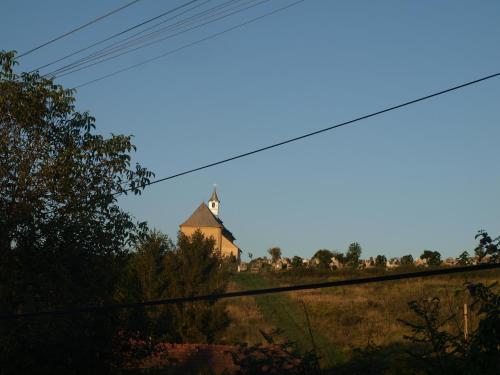 a church on top of a hill with power lines at Rozsa Haz in Csernely