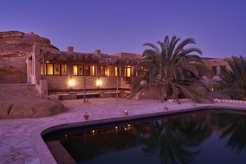a house with a swimming pool in front of it at Talist Siwa in Siwa