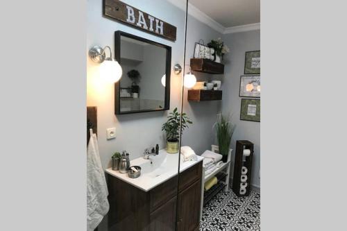 a bathroom with a sink and a mirror at OrchardHouse Farmhouse, wellness in Chrast