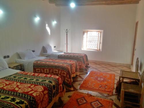 A bed or beds in a room at Riad Amodou