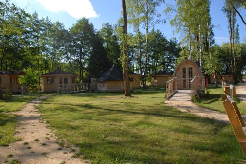 a large yard with houses and a playground at Le Petit Robinson in Champvert