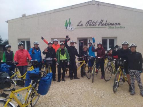 a group of people standing in front of a building with their bikes at Le Petit Robinson in Champvert