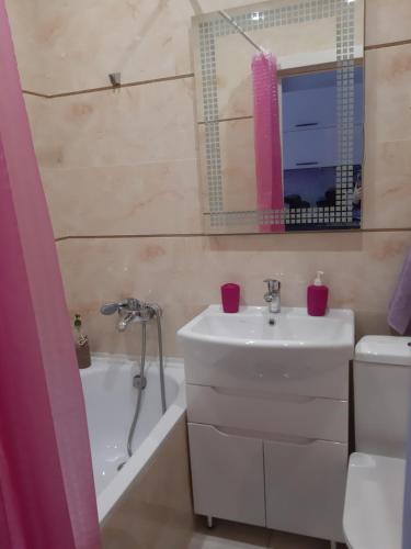 a bathroom with a sink and a toilet and a tub at Апартаменты. Холодная гора, ул. Дудинской 1а. in Kharkiv