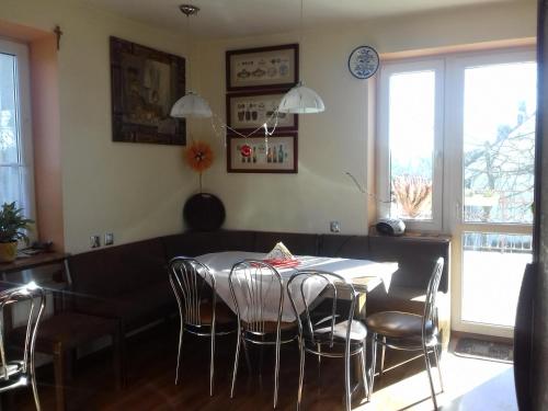 a dining room with a table and chairs at Homestay Stróżówka in Gorlice