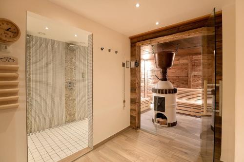 a bathroom with a shower and a glass door at Elements Hotel Christlessee in Oberstdorf