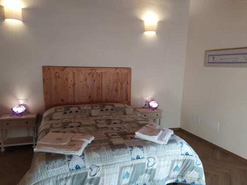 a bedroom with a large bed with a wooden headboard at Il Mulino di Celle in Pistoia