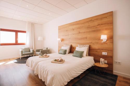 a hotel room with two beds with towels on them at Garachico Homes - LA CASA DE LINA in Garachico