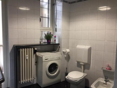 a bathroom with a washing machine and a washer at House Torêt in Turin