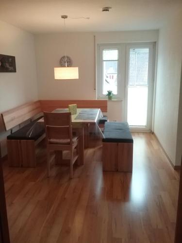 a dining room with a table and a chair at Ferienwohnung "SCHÖNBUCH" , Pension Wauri in Waldenbuch