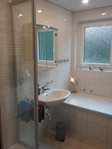 a bathroom with a sink and a shower and a tub at Ferienwohnung "SCHÖNBUCH" , Pension Wauri in Waldenbuch
