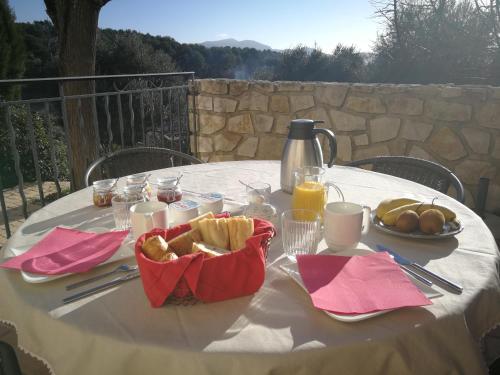 a table with a white table cloth with food on it at la Cigalette in Peypin