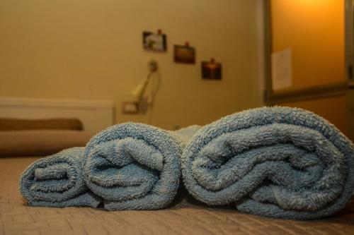two large towels sitting on top of a bed at B&B Annalu' in Guspini