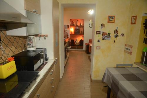 a kitchen with a counter with a microwave and a hallway at B&B Annalu' in Guspini