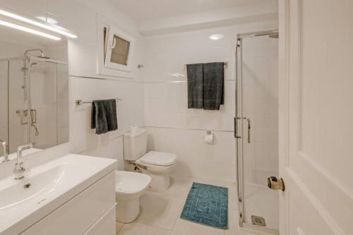 a bathroom with a toilet and a sink and a shower at terrazza e vista sull'oceano, Wi-Fi, piano 3, piscina sullo stesso piano in Morro del Jable