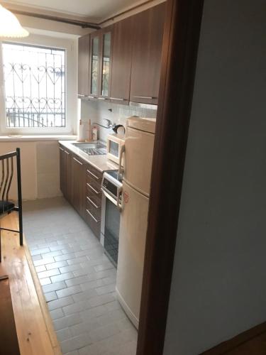 a kitchen with a refrigerator and a stove top oven at Feel like home guest house in Sarajevo
