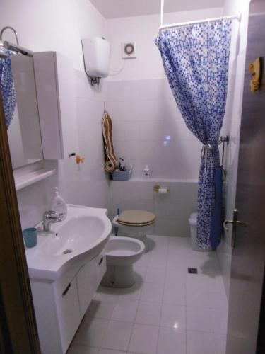a bathroom with a sink and a toilet and a shower at Affittacamere Girasole in Foligno