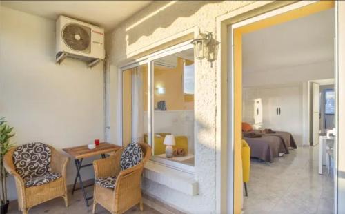 a room with a table and chairs and a bedroom at Casa María Carihuela Park Palace in Torremolinos