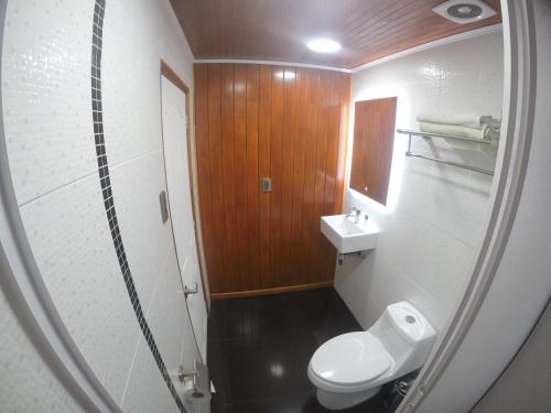 a small bathroom with a toilet and a sink at VOY Hostales - Poniente in Viña del Mar