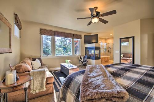 a living room with a bed and a ceiling fan at Sugar Bear Lodge with Game Room - 5 Mi to Village! in Lake Arrowhead