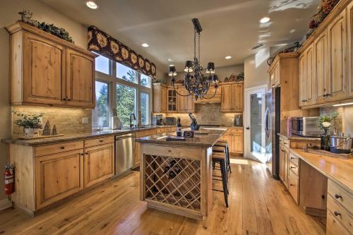 a large kitchen with wooden cabinets and a large island at Sugar Bear Lodge with Game Room - 5 Mi to Village! in Lake Arrowhead