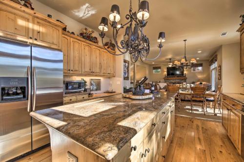 a large kitchen with wooden cabinets and a large island at Sugar Bear Lodge with Game Room - 5 Mi to Village! in Lake Arrowhead