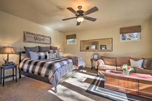 a bedroom with a bed and a couch and a ceiling fan at Sugar Bear Lodge with Game Room - 5 Mi to Village! in Lake Arrowhead