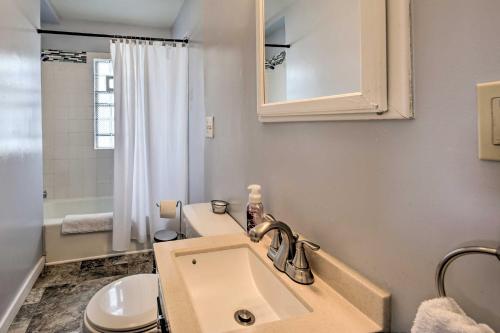 a bathroom with a sink and a toilet and a mirror at The Cozzy House 4-Minute Drive to Miller Park! in West Allis