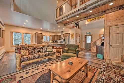 a living room with a couch and a table at Rustic 3-Story Pittsburg Cabin with Lake and Mtn Views in Pittsburg