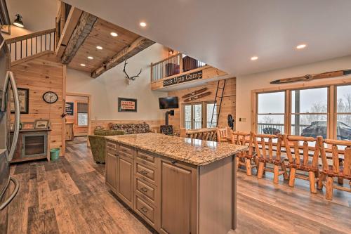 a kitchen and living room in a log cabin at Rustic 3-Story Pittsburg Cabin with Lake and Mtn Views in Pittsburg