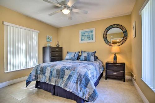 a bedroom with a bed with a ceiling fan and a mirror at Ideally Located Abode with Gazebo in Pompano Beach! in Pompano Beach