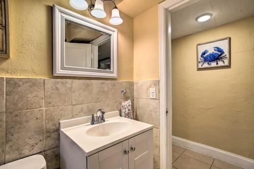 a bathroom with a sink and a mirror at Ideally Located Abode with Gazebo in Pompano Beach! in Pompano Beach