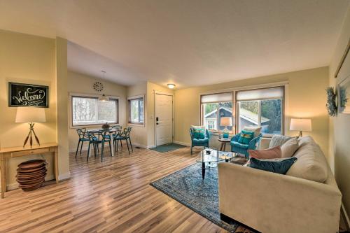 a living room with a couch and a table at Cute Cottage with Deck Walk 115 Ft to Brewery and Cafe in Poulsbo