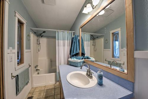 a bathroom with a sink and a mirror at Cute Cottage with Deck Walk 115 Ft to Brewery and Cafe in Poulsbo