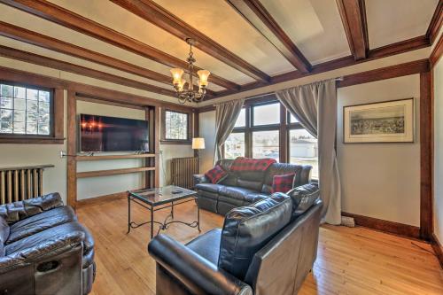 a living room with leather furniture and a chandelier at Pet-Friendly Sheboygan Home, 1 Mi to Lake Michigan in Sheboygan
