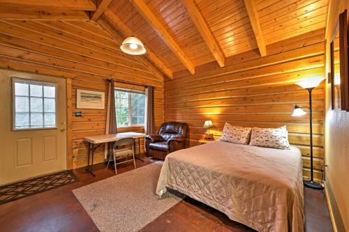 a bedroom with a bed and a desk and a chair at Cozy Cabin on the Creek Near Hiking Trails and Town! in Seward