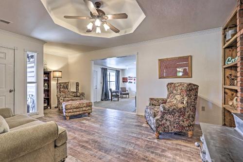 a living room with a ceiling fan and chairs at The Eagar House White Mountains Gem with Views! in Springerville