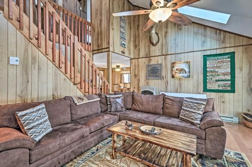 a living room with a couch and a ceiling fan at Game Room and Golf Cart Bear Den Pocono Lake Home in Pocono Lake