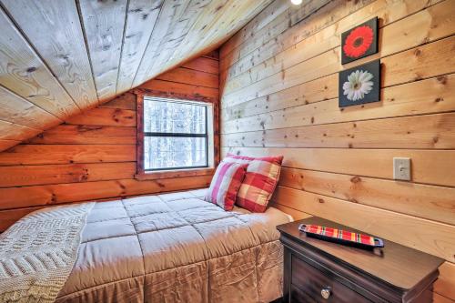a bedroom with a bed in a log cabin at Furnished Deck Cabin in Coconino National Forest in Munds Park