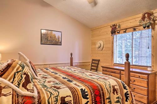 a bedroom with a bed and a window at Bright and Cozy Duck Creek Cabin with Grill and Fire Pit in Duck Creek Village