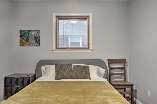 a bedroom with a bed with a window and a chair at Mid-Century Gem Dog-Friendly Home Near DC! in Rockville