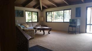a living room with a couch and a table at Waiotemarama Falls Lodge in Opononi