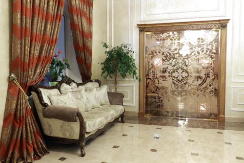 a living room with a couch and a large door at Hotel Aristokrat in Poltava