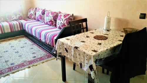 een woonkamer met een tafel en een bank bij Appart au Centre de Rabat مرحبا in Rabat