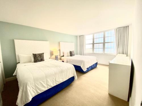 a hotel room with two beds and a window at Seacoast by Miami Ambassadors in Miami Beach