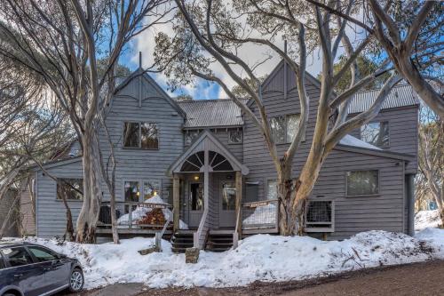 a gray house with a car parked in front of it at Welkuminn in Dinner Plain